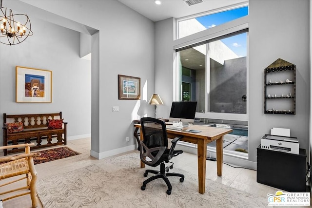 office space with light wood-type flooring and a notable chandelier