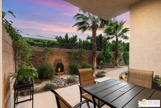 view of patio terrace at dusk