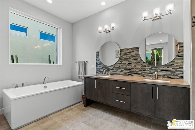 bathroom featuring backsplash, a bath, and vanity