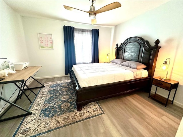 bedroom with ceiling fan and hardwood / wood-style flooring