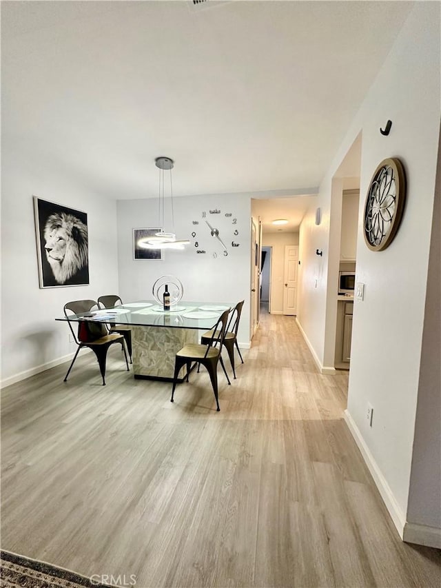 dining area with light hardwood / wood-style flooring