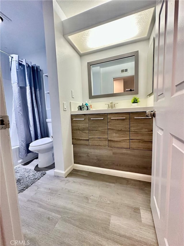 full bathroom with toilet, vanity, shower / bath combination with curtain, and a textured ceiling