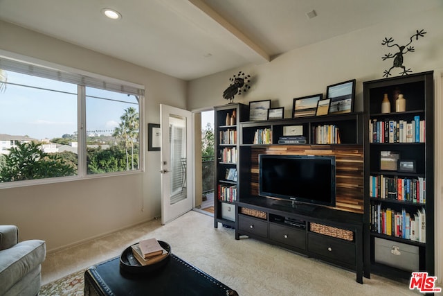 living room featuring light carpet and beamed ceiling