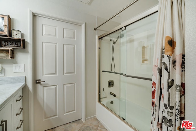 bathroom featuring bath / shower combo with glass door, tile patterned floors, and vanity