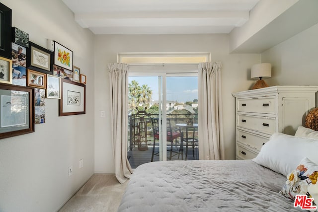 carpeted bedroom featuring access to exterior and beamed ceiling