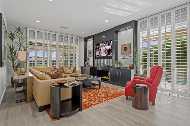 living room with light wood-type flooring and plenty of natural light