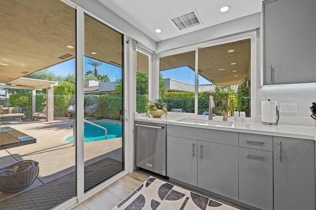 entryway with sink and light wood-type flooring