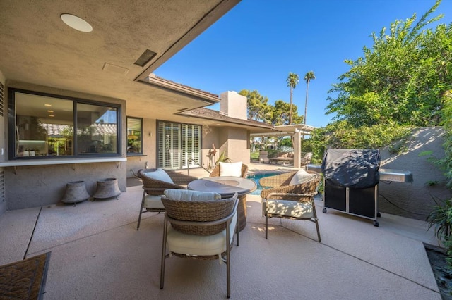 view of patio with grilling area and outdoor lounge area