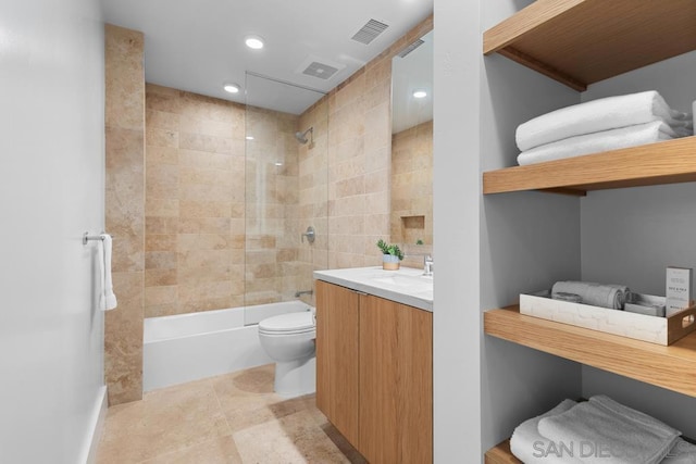 full bathroom featuring toilet, vanity, and tiled shower / bath