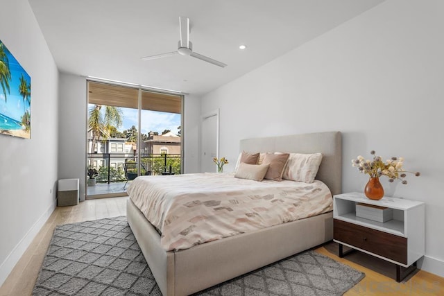 bedroom with light hardwood / wood-style floors, access to exterior, ceiling fan, and floor to ceiling windows