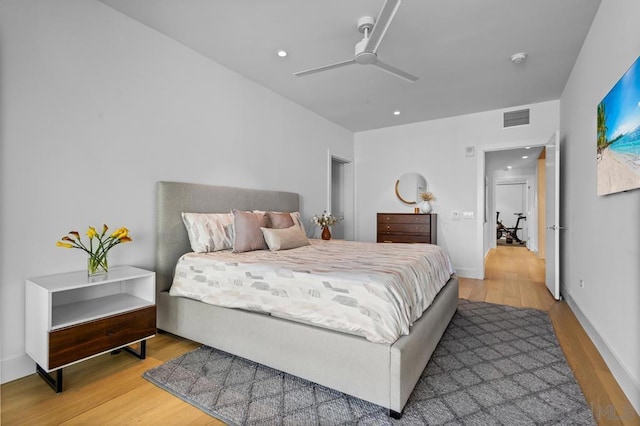 bedroom with ceiling fan and hardwood / wood-style floors