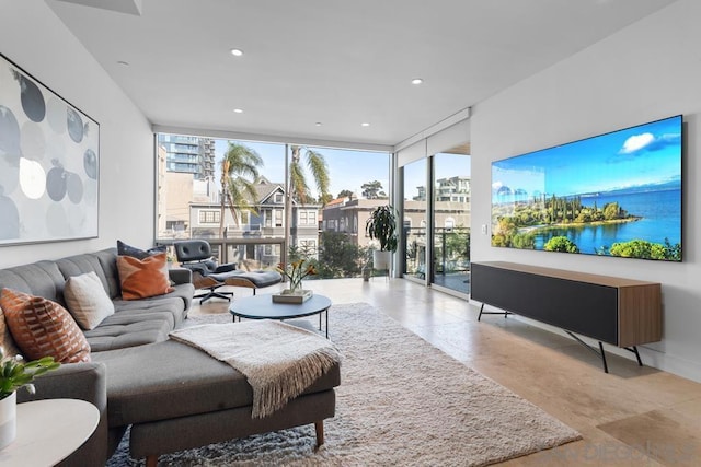 living room featuring a wealth of natural light and floor to ceiling windows