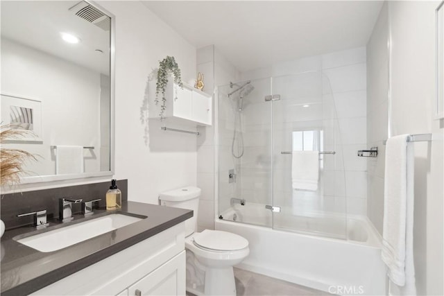 full bathroom featuring toilet, bath / shower combo with glass door, and vanity