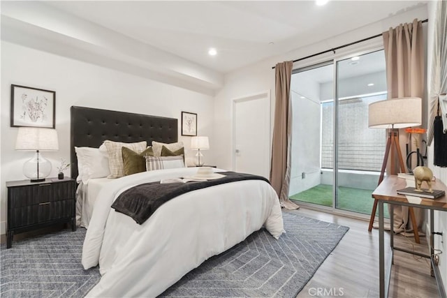 bedroom featuring access to exterior and hardwood / wood-style flooring