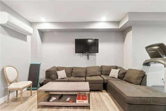 living room featuring a wall mounted AC and light wood-type flooring