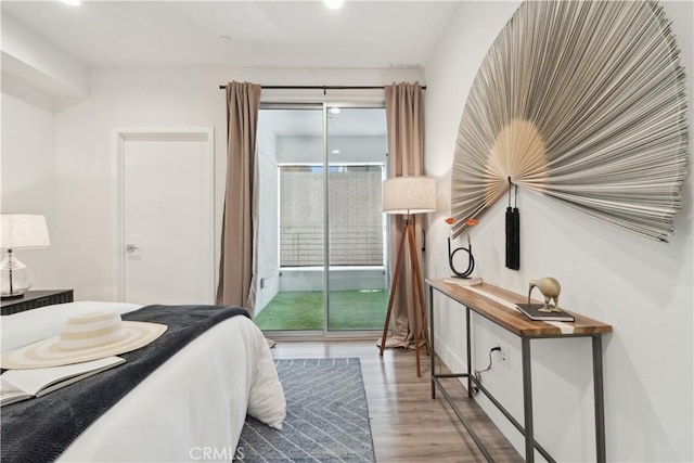 bedroom featuring hardwood / wood-style floors and access to outside