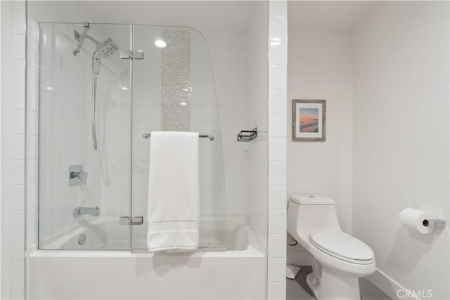 bathroom featuring toilet and tiled shower / bath combo