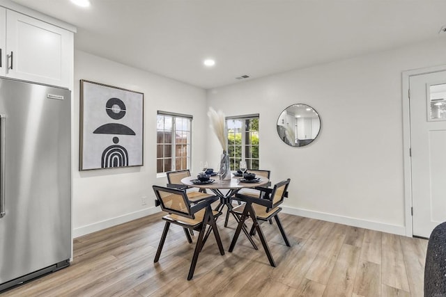 dining space with light hardwood / wood-style floors