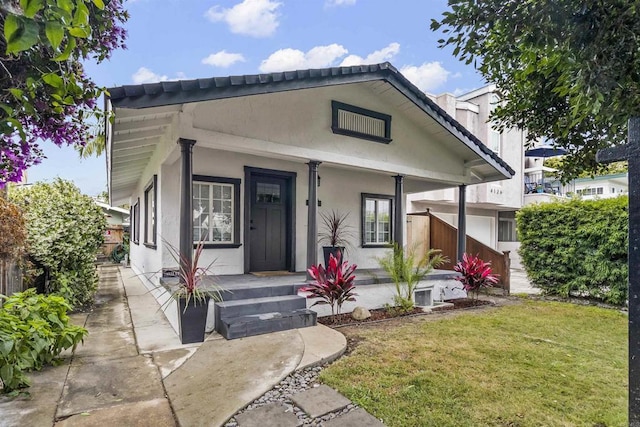 bungalow-style home featuring a front yard and a porch