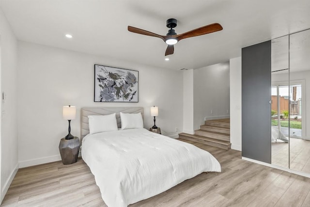 bedroom featuring ceiling fan, light hardwood / wood-style floors, and access to exterior