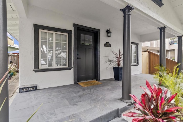 entrance to property featuring covered porch