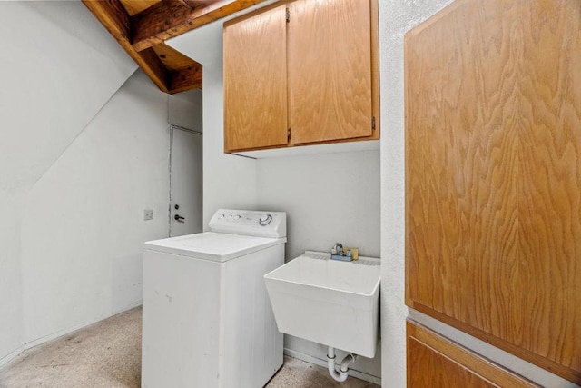 washroom featuring washer / clothes dryer, sink, and cabinets