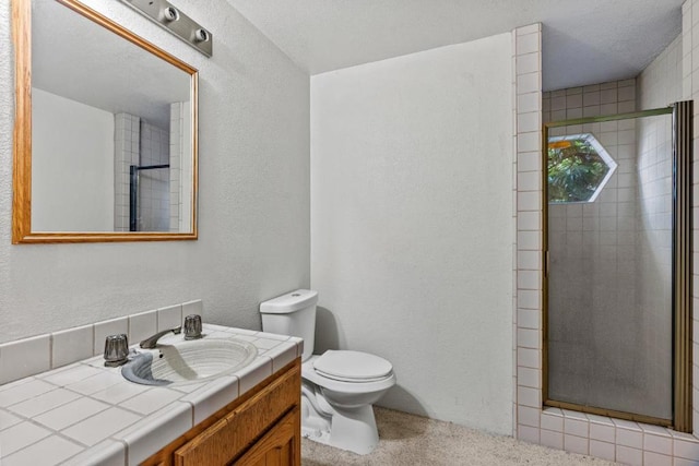 bathroom featuring walk in shower, vanity, and toilet