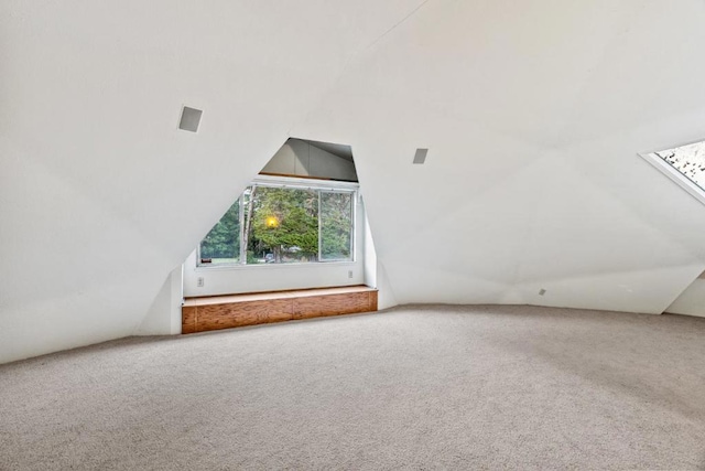 bonus room featuring carpet floors and vaulted ceiling