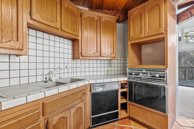 kitchen featuring black appliances, tile counters, tasteful backsplash, sink, and light tile patterned floors