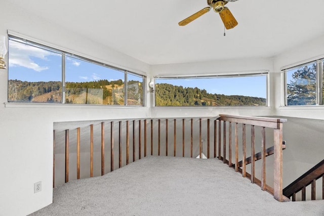 unfurnished sunroom with ceiling fan