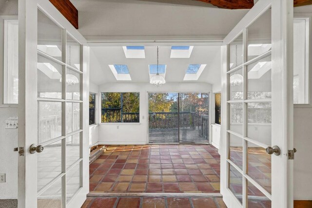 unfurnished sunroom with lofted ceiling and french doors