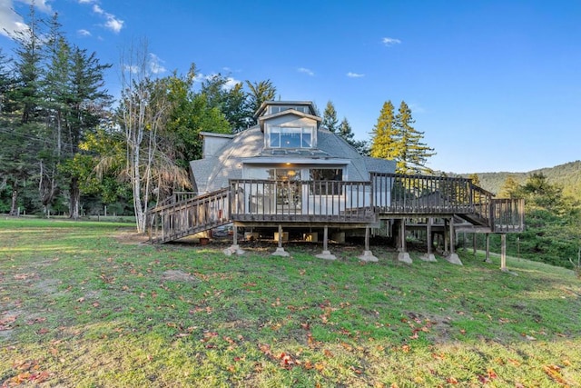 back of property featuring a lawn and a deck