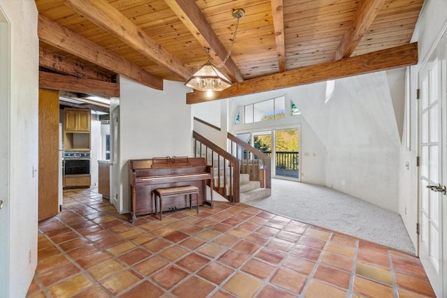 foyer with carpet floors, wooden ceiling, a notable chandelier, and beamed ceiling