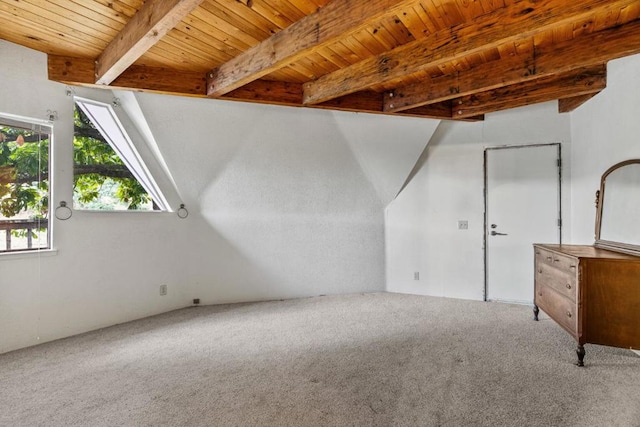 additional living space with wood ceiling, beamed ceiling, and carpet flooring