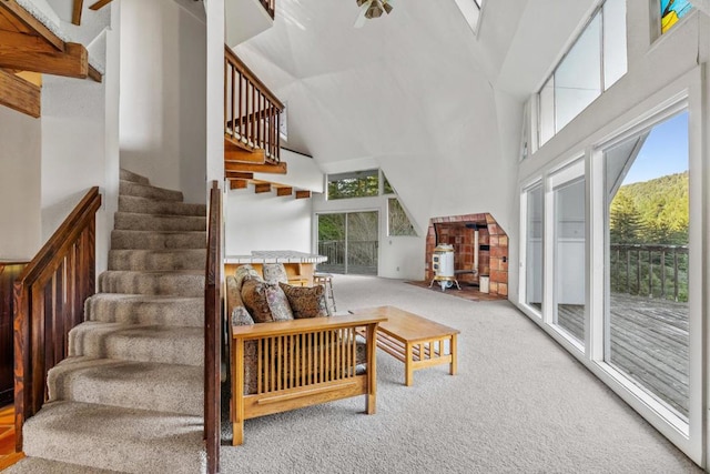 living room featuring carpet, plenty of natural light, and a high ceiling