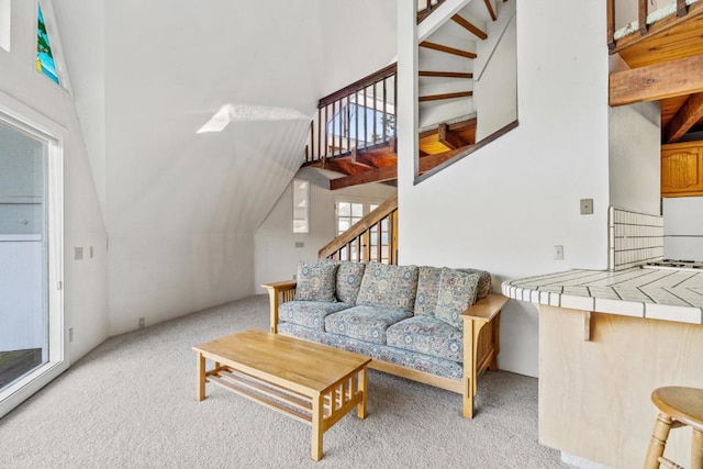 living room with vaulted ceiling and light colored carpet