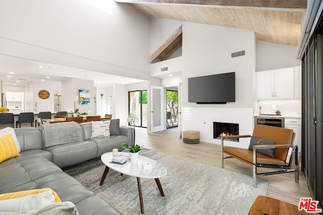 living room with wood ceiling, high vaulted ceiling, and light wood-type flooring