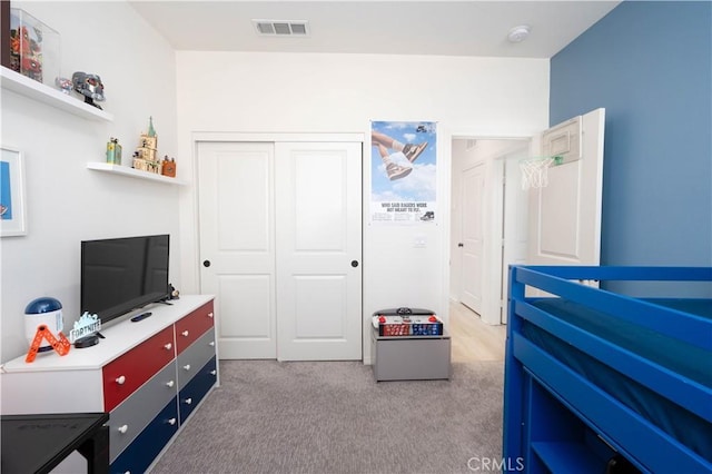 bedroom with light colored carpet and a closet