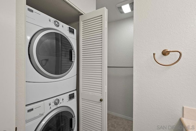 laundry room with stacked washer and clothes dryer