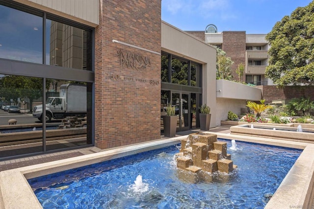 view of pool with pool water feature