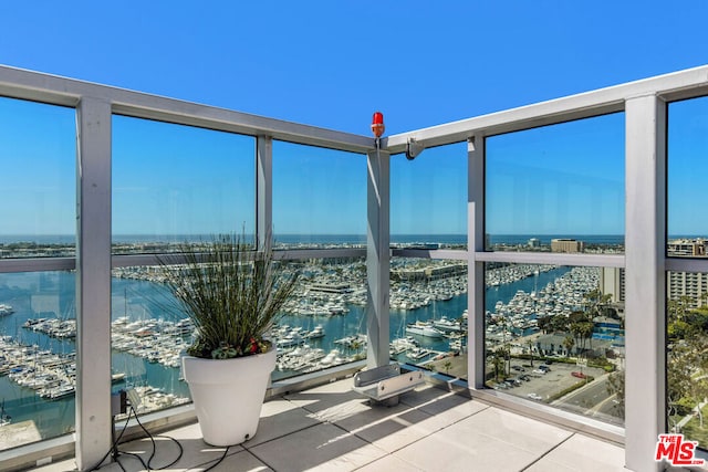 unfurnished sunroom featuring a water view