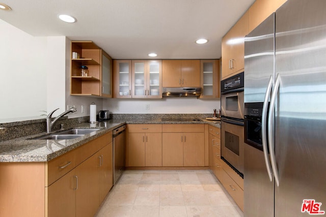 kitchen featuring light brown cabinets, sink, dark stone countertops, and stainless steel appliances