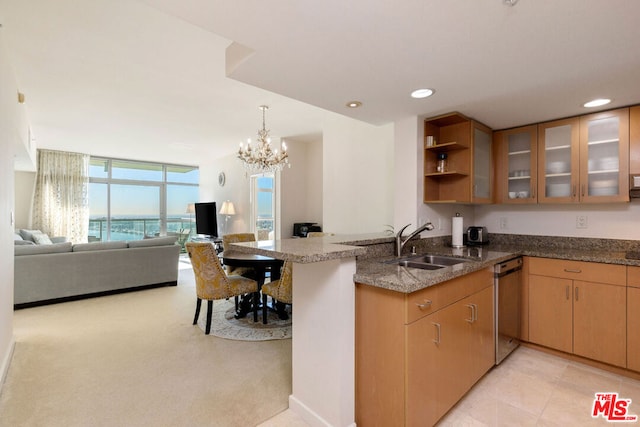 kitchen with dishwasher, sink, stone countertops, kitchen peninsula, and a chandelier