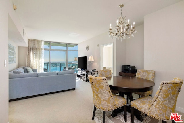 dining space featuring floor to ceiling windows, carpet flooring, and an inviting chandelier