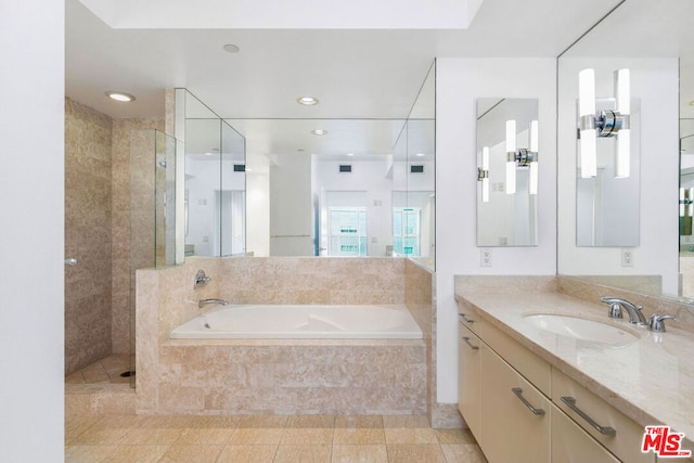 bathroom with tile patterned flooring, separate shower and tub, and vanity