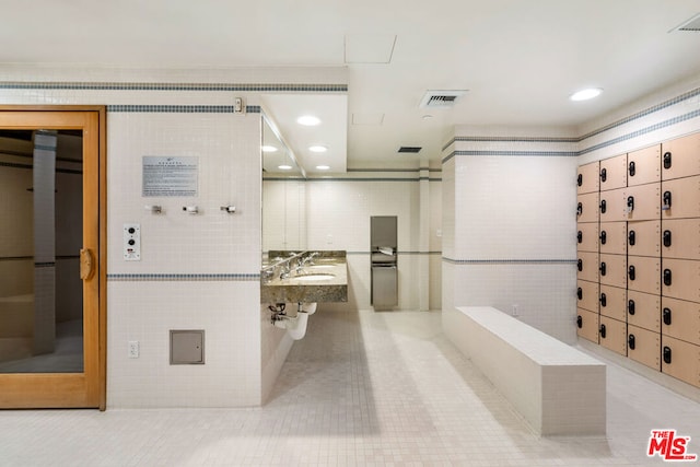 bathroom with tile patterned flooring and tile walls