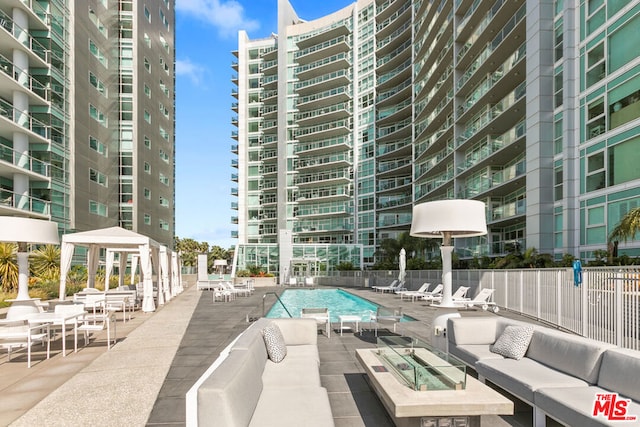 view of swimming pool featuring an outdoor living space and a patio