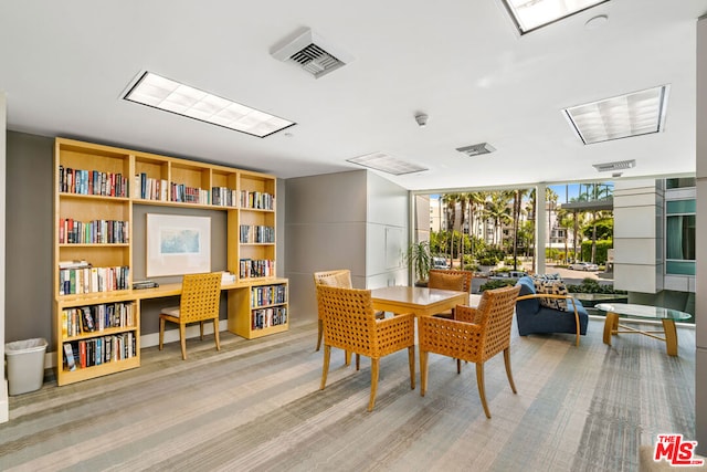 dining area featuring light carpet and floor to ceiling windows