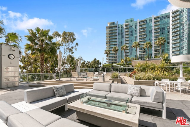 view of patio / terrace featuring a hot tub and an outdoor living space