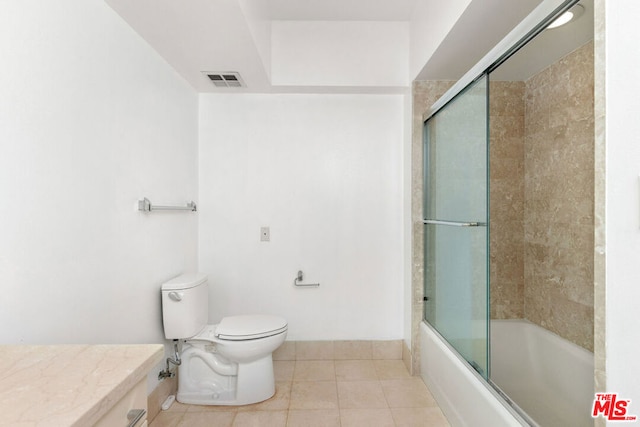 bathroom with toilet, enclosed tub / shower combo, and tile patterned flooring